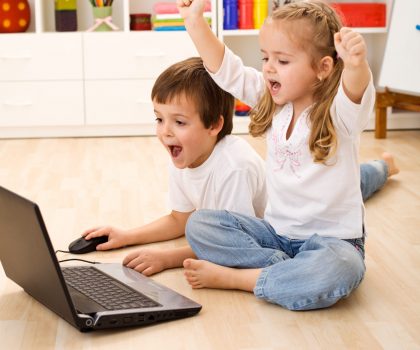 shutterstock_two kids preschoolers in front of a computer